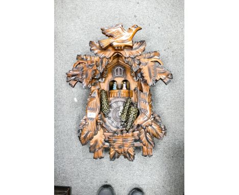 Large modern wooden cuckoo clock, not in working order, quartz movement. 
