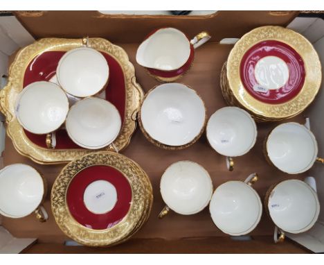 Aynsley burgundy and gold gilt tea ware items to include 9 cups (1 a/f) 11 saucers, 12 side plates, milk/sugar and 2 cake pla