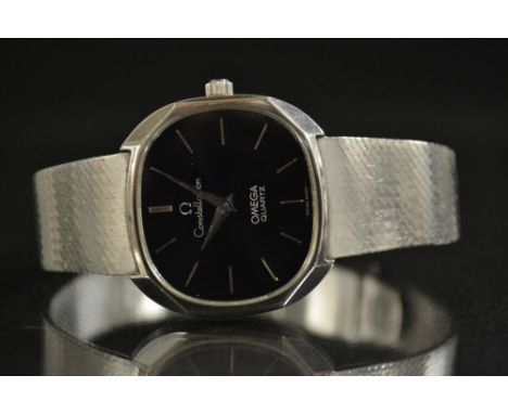 Omega - a vintage 1970s Constellation quartz stainless steel wristwatch, oval black dial, stainless steel bar batons, taperin