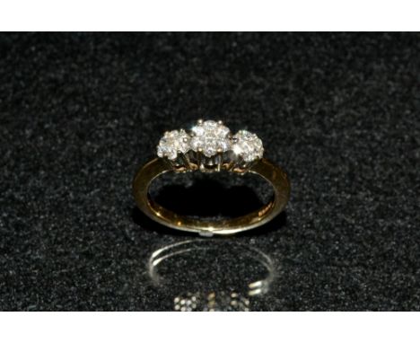 A diamond triple flower head cluster ring, each round floral cluster composed of seven round cut diamonds, total estimated di