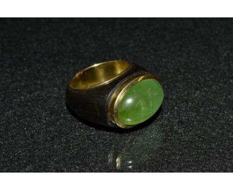 An emerald, ebony and 18ct gold dress ring, single oval cabochon emerald, approx 11.60ct, collet set to an ebony and 18ct gol