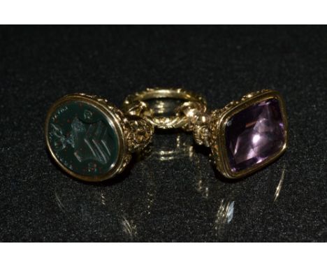 A decorative bloodstone set seal fob, the yellow metal mount with chased and cast floral scrolls, the oval bloodstone matrix 