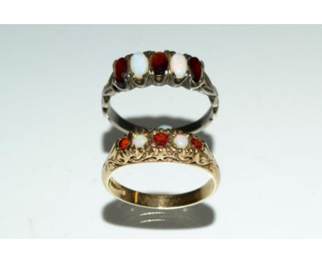 An opal and garnet quintet ring, alternate set with three red garnets and two white opal cabochons, 9ct gold shank, Sheffield