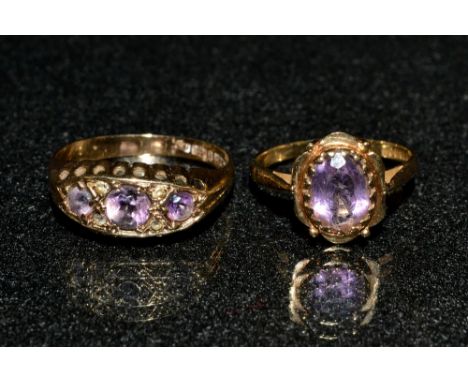 An amethyst dress ring, oval pinky purple amethyst crown claw, shaped frame, 9ct gold shank, size L; another seven stone, 9ct