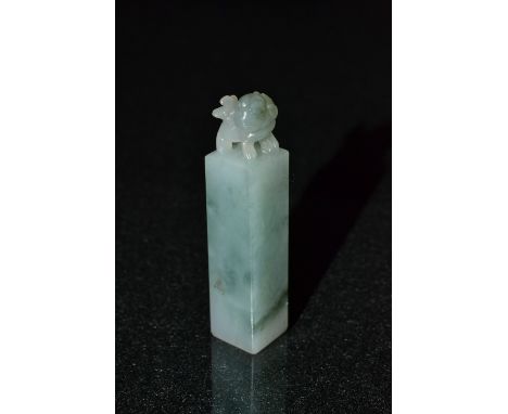 A Chinese carved jade Shi/Foo Dog topped seal stamp, block body, quartered seal stamp matrix, 52mm long 