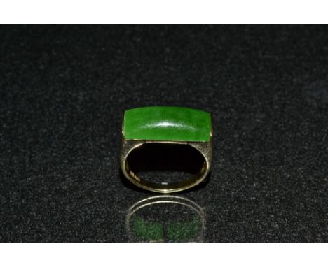 A green jade signet ring, domed rectangular jade cabochon sunken into an 8ct gold shank, stamped 333, size S, 5.5g gross