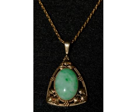 An Art Nouveau stained jade mounted pendant, oval jade cabochon, inset to an open cast rounded triangular 9ct gold ornate flo