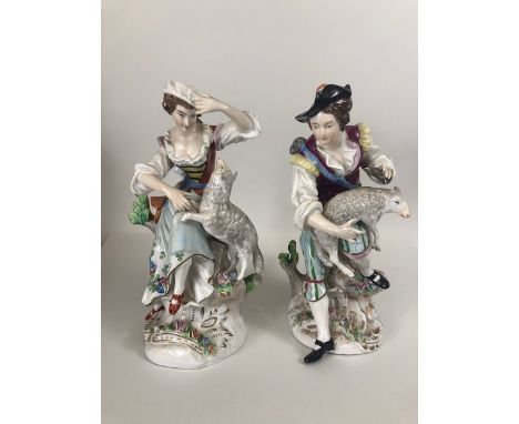 Continental  porcelain, pair of figures from the Sitzendorf factory Germany, depicting a young man and woman playing with lam