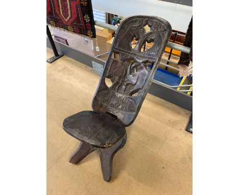 Tribal art interest, early 20th century African birthing chair, dark patinated wood with animal carvings 