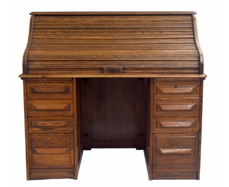 Early 20th century twin-pedestal roll top desk, the tambour enclosing fitted interior with stationery pigeon holes and drawer