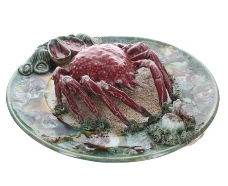 Palissy style majolica crab plate, decorated with moulded sea shells to the border and sand textured centre, 13" diameter 