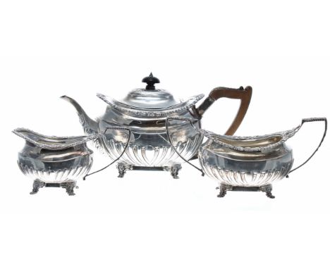 Victorian silver three piece tea set,&nbsp;half reeded with cast shell rim borders, the teapot with hardwood handle and finia