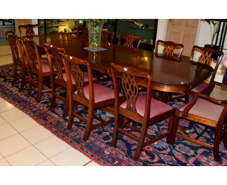 Charles Barr reproduction mahogany twin-pedestal dining table with three additional leaves;  a set of twelve Chippendale revi