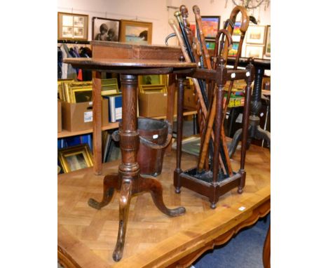 An oak tripod table and a stick stand with a collection of sticks 