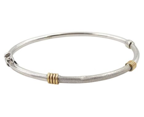 9ct white and yellow gold hinged bangle, hallmarkedCondition Report:Approx 4.65gm, inner circumference 18cm, dents to body, h