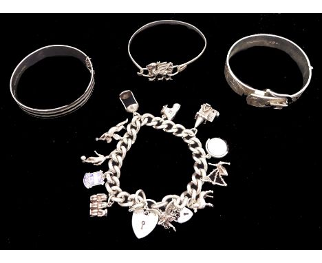 Silver jewellery including curb link bracelet with heart locket clasp and eleven charms including poodle, cherub and three wi