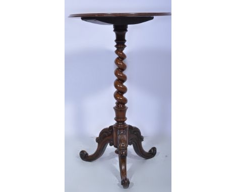 Victorian rosewood and stained wood pedestal table, circular top with a moulded edge, spiral twist column, on carved gold tri
