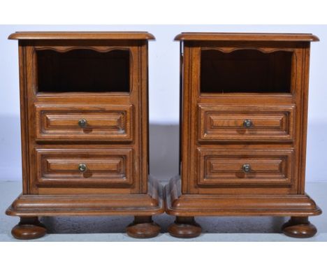 Pair of reproduction oak bedside tables, each with an open shelf over two drawers, width 47cms.