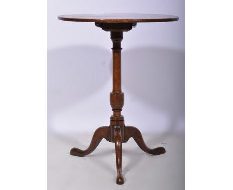 Georgian oak pedestal table, circular tilt top, baluster column, tripod legs, diameter 55cms.