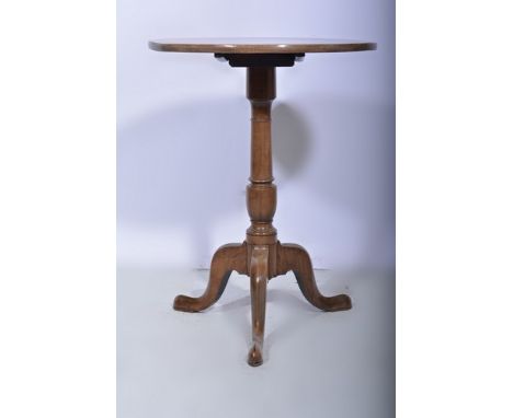 Georgian oak and elm pedestal table, circular tilt top with a moulded edge, baluster column, tripod legs, diameter 59cms.
