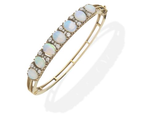 OPAL AND DIAMOND BANGLE, CIRCA 1890 Of hinged design, the graduating opal cabochons interspersed with cushion-shaped diamonds