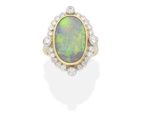 OPAL AND DIAMOND CLUSTER RING The oval opal cabochon, within a brilliant-cut diamond surround, mounted in 18 carat gold, diam