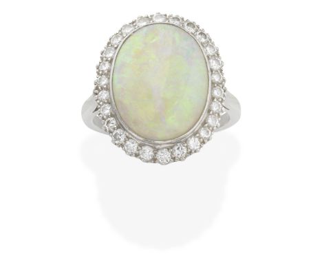 OPAL AND DIAMOND RING The cabochon-cut opal within a brilliant-cut diamond surround, diamonds approx. 0.50ct total, ring size