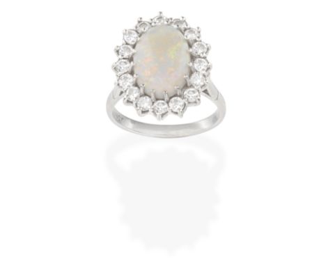 OPAL AND DIAMOND RING The oval opal cabochon within a brilliant-cut diamond surround, diamonds approx. 0.80ct total, ring siz