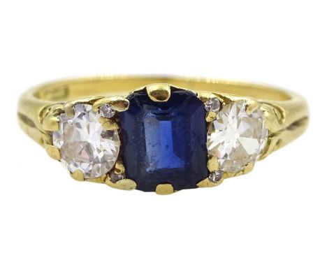 Early 20th century 18ct gold three stone emerald cut sapphire and old cut diamond ring, with four diamond accents set between