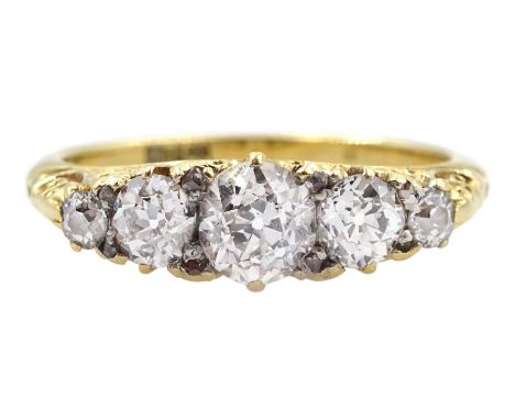 Early 20th century gold graduating five stone old cut diamond ring, with diamond accents set between, stamped 18ct, principal