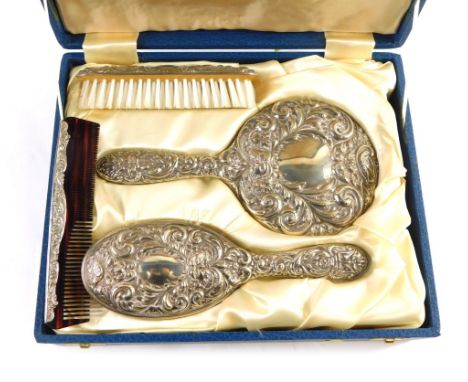 An Elizabeth II four piece silver dressing table set, comprising hairbrush, clothes brush, hand mirror, and comb, each piece 