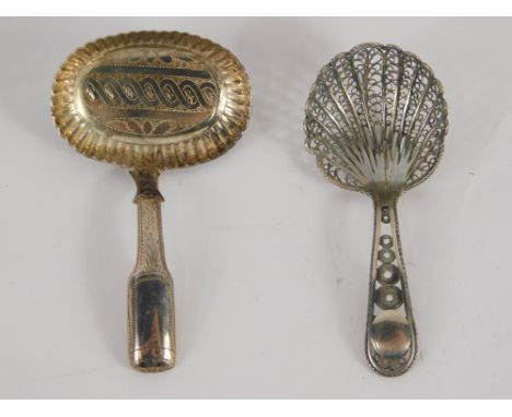 A George IV silver caddy spoon, with fancy oval bowl and elaborate stem, Birmingham 1824, 7cm long, and another pierced examp