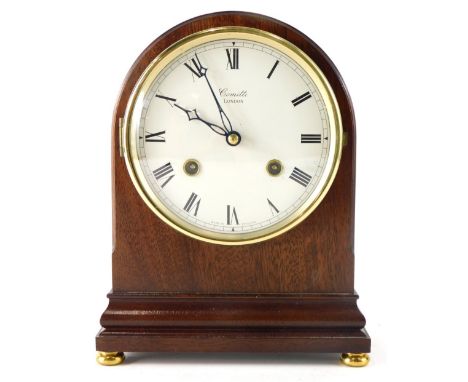 A Comitti London mahogany cased mantel clock, the domed case holding a 13cm diameter Roman numeric dial, on compressed orb fe