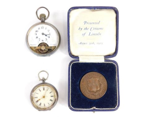 An early 20thC fob watch, with fancy 3cm diameter Roman numeric dial, in engine turned case, with vacant cartouche, marked 0.