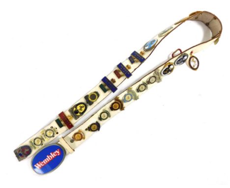 A leather sash, set with many steward badges for Horse of the Year Show, Wembley Stadium, member of the RIHS 1977, various ot