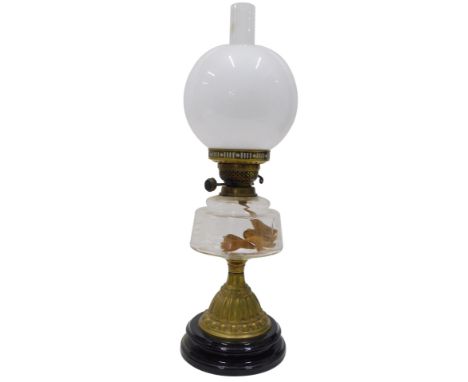 An early 20thC oil lamp, with brass mounts, plain glass reservoir, bell shaped stem and milk glass shade, clear funnel, 47cm 