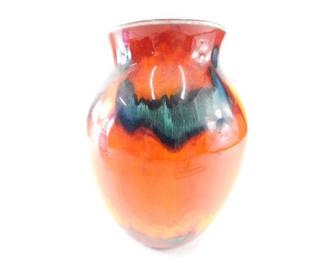 A Poole Volcano medium classic vase, decorated with flower heads on an orange ground with blue interior, labelled beneath, 21