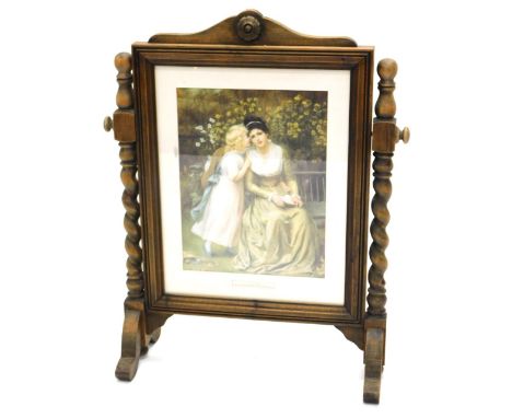 A early 20thC firescreen, with printed centre A Great Secret, on scroll feet surmounted by a floral roundel, 76cm high.