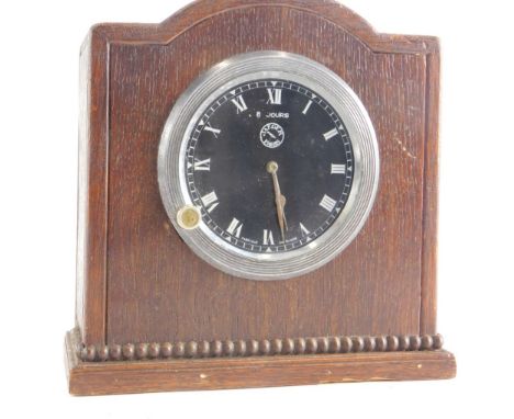 An automobile Rolls Royce style clock movement, 8cm diameter, in an oak case, possibly 1924, marked verso, the case 17cm high