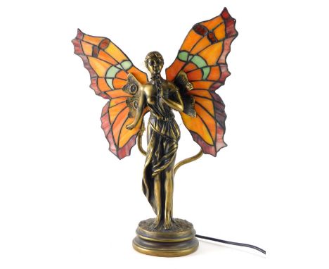 A Tiffany style table lamp, formed as an angel with glass wings with wolves behind, 42cm high. 