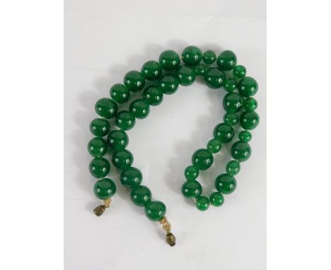 A jade coloured bead necklace, set with various sized orbs, 1cm diameter, etc., 46cm long.
