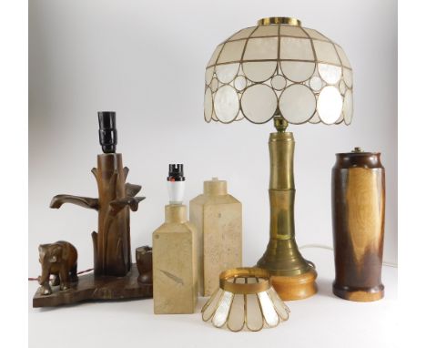 Two similar carved stone lamp bases, each engraved Lincoln 1972, a brass lamp base, a turned lignum lamp base, another in ori