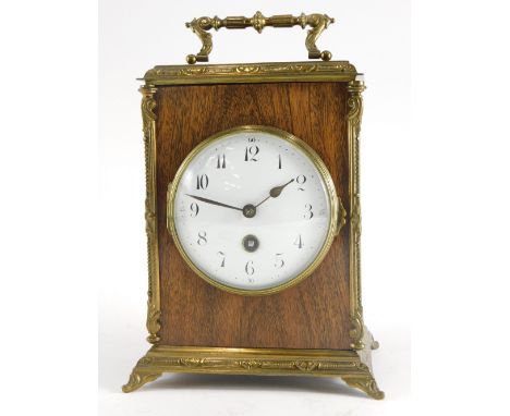 A French mahogany and brass carriage timepiece, with hinged handle, with white enamel dial with Arabic numerals, on bracket f