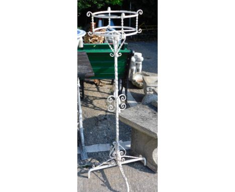 A wrought iron plant stand, with turned scroll stem, on quadruple feet, with circular planter, 110cm high. 