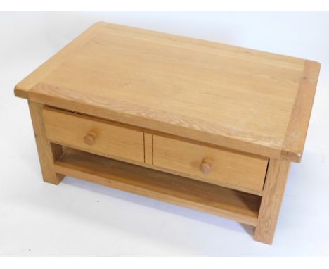 A light oak rectangular coffee table, with a double sided drawers, 50cm high, 70cm wide.