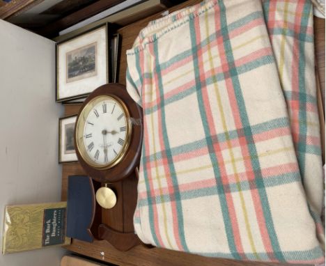 A wall clock together with a blanket, prints, books etc