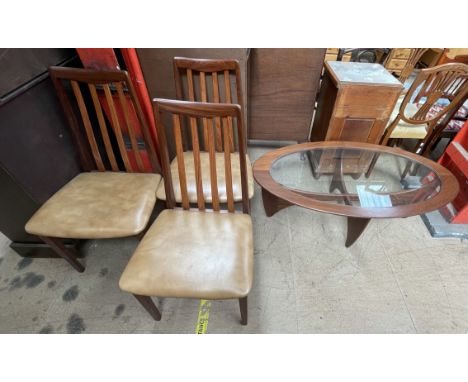 A set of three mid 20th century G-Plan teak dining chairs together with a mid 20th century teak coffee table of oval form wit