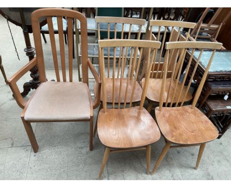 A set of four Ercol Beech stick back and elm seated dining chairs together with another chair