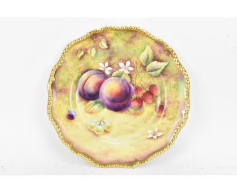 A Royal Worcester fruit decorated cabinet plate, of shaped circular form, hand painted with still lives of fruit and signed B
