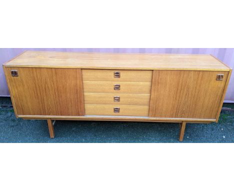 A Möbel-Ikea vintage walnut "Köln" sideboard, Sweden 1960s, having four drawers flanked by two cupboard doors and supported o